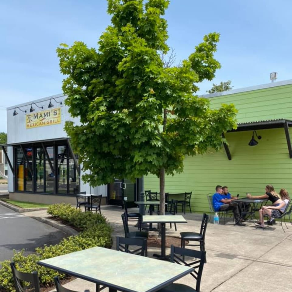 Mami's Mexican Grill exterior with outdoor seating, a large tree, and customers dining.
