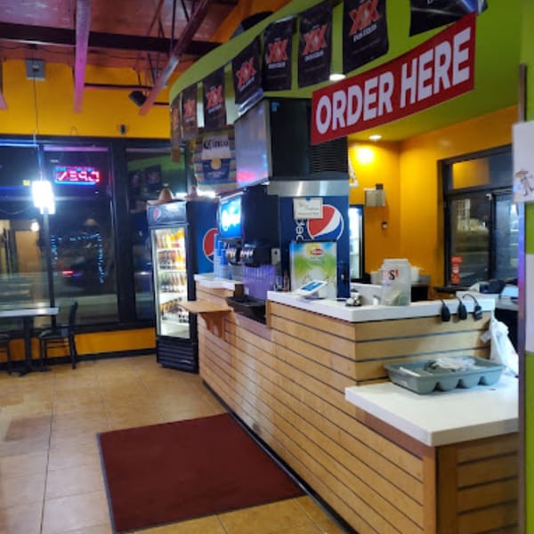 The interior of Mami's Mexican Grill, showing the ordering counter, drink dispensers, and seating area.